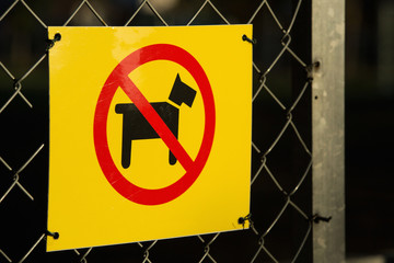 A sign on the fence. It is forbidden to enter the area with dogs. Dog walking is prohibited.