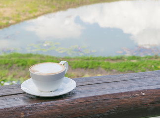 Close up white cup of Coffee, latte on the wooden table