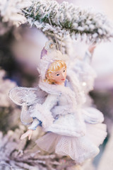 Small toy Snow Maiden in white snow dress as decoration of Chris