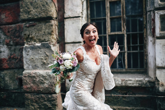 Bride with flowers running on the street