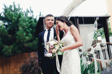 Happy bride and groom near the arch