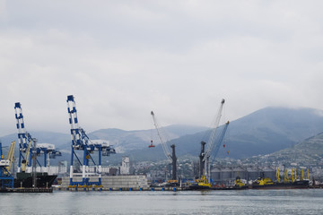 Fototapeta na wymiar The international sea port of Novorossiysk. Port cranes and industrial objects. Marine Station.