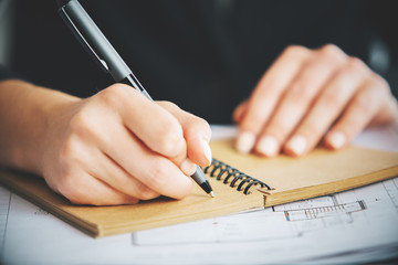 Lady writing in notepad