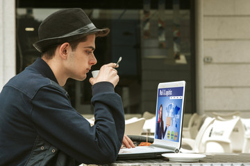young man with the laptop in the coffee shop