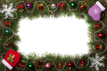 Christmas frame made of fir branches decorated with bells and balls isolated on white background