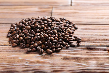 Roasted coffee beans on a brown wooden table