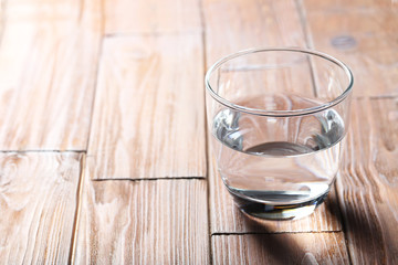 Glass with water on a brown wooden table