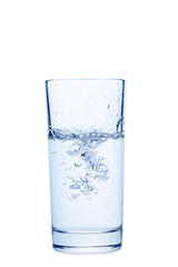 Water pouring in glass isolated on a white