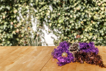 Christmas wreaths on wooden table in front of a green background