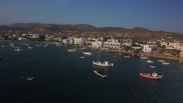 Aerial of great number of little boats and dinghies moored in the harbour of fishing village of Alyki on the island of Paros, Greece.