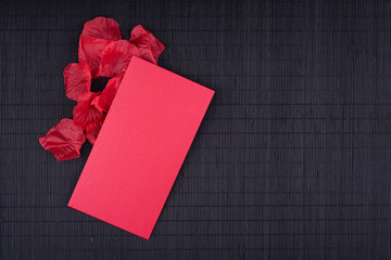 lucky money in red envelope and rose petals