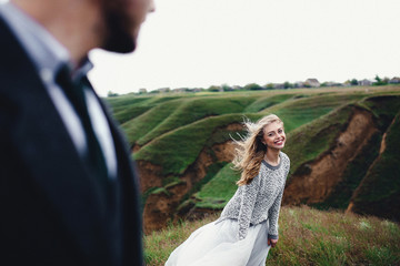 Groom looks on his bride