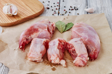 Rabbit meat with garlic pepper on a wooden background