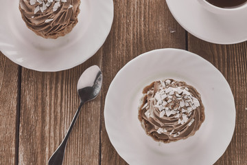 Air cake in a basket with chocolate cream and coffee on a wooden background