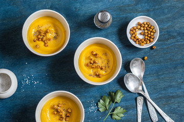 Sweet potatoes soup with spicy chickpea. On a wooden table, top view. Flat lay