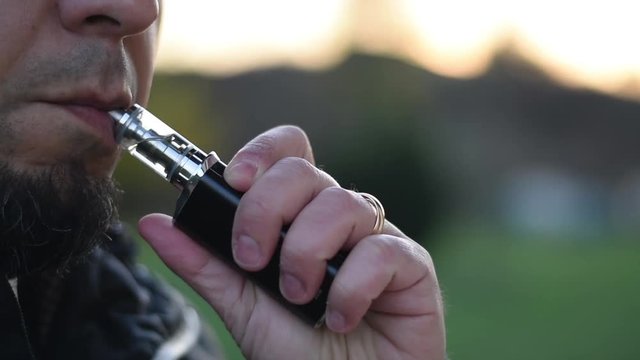 Close-Up of Man Vaping An Electronic Cigarette.