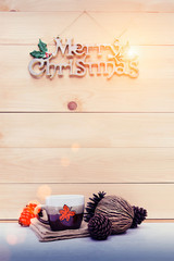 Christmas cup with pine and Christmas decorated on wooden table.