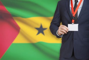 Businessman holding name card badge on a lanyard with a national flag on background - Sao Tome and...