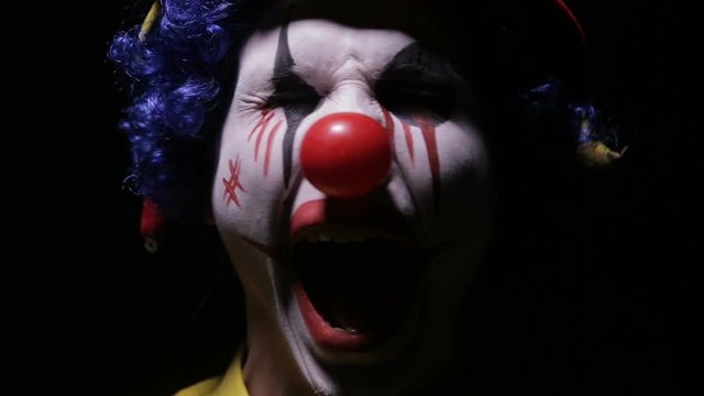 Evil, horror clown man looking into camera. HD