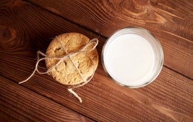 Cookies and milk. Chocolate chip cookies and a glass of milk. Vintage look. Tasty cookies and glass of milk on rustic wooden background. Food, junk-food, culinary, baking and eating concept