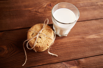Cookies and milk. Chocolate chip cookies and a glass of milk. Vintage look. Tasty cookies and glass of milk on rustic wooden background. Food, junk-food, culinary, baking and eating concept