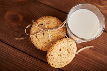 Cookies and milk. Chocolate chip cookies and a glass of milk. Vintage look. Tasty cookies and glass of milk on rustic wooden background. Food, junk-food, culinary, baking and eating concept