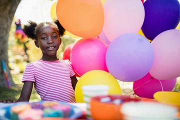 Fototapeta na wymiar Cute girl posing next to balloon on a birthday party