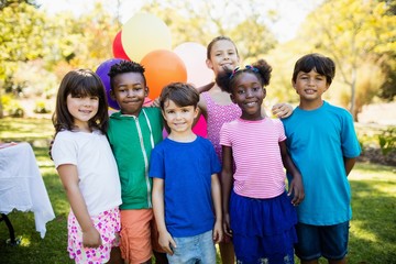 Cute children standing and posing during a birthday party