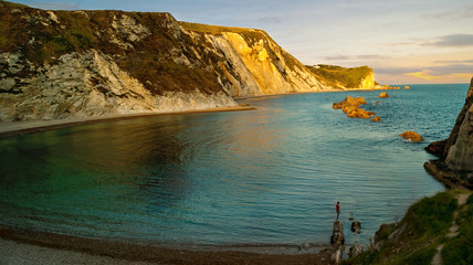 Fototapeta na wymiar A very popular beach of sand and fine pebbles on the east side of Durdle Door; Jurassic Coast; Dorset; England; United Kingdom