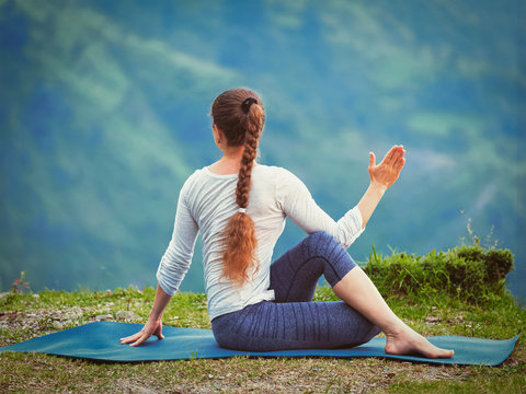 Woman practices yoga asana outdoors
