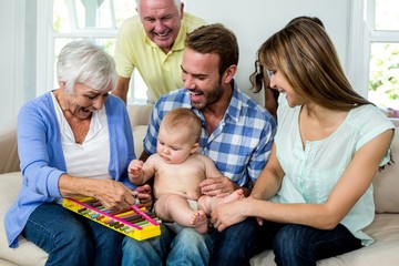 Multi-generation family showing xylophone to baby boy