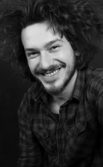 Fototapeta premium Portrait of a fashionable young man on dark background, chalkboa