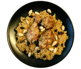 Arabic food: kabsa with chicken and almonds in plate with white background