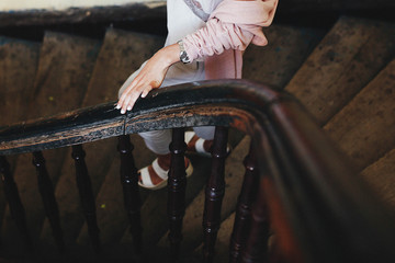 delicate female hand with manicure on wooden railing