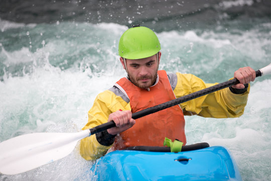 Teenage man paddling in a kayak