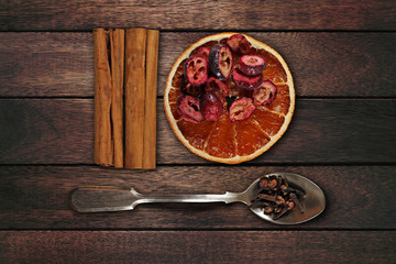Set spices for mulled wine on dark wooden background.