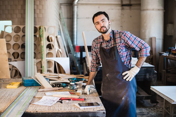 Carpenter working carefully looking at the plans