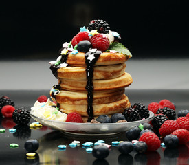 Pancakes with berries and maple syrup