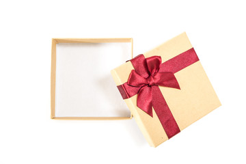 Paper gift box with deep red ribbon with a bow, on white background.