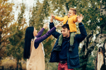 Young family have fun in park selective focus on man face