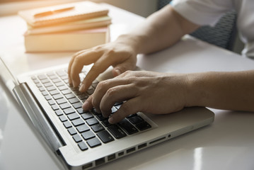 Photo closeup of a man's hand,using laptop.
