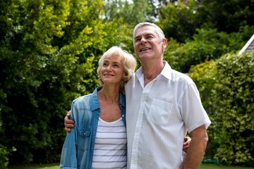 Senior couple looking up in back yard