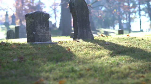 Burial sites in cemetery during sunrise.