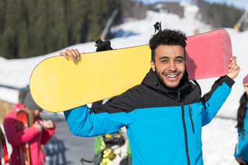 Hispanic Man Hold Snowboard Ski Resort Winter Snow Mountain Cheerful Happy Smiling Guy Holiday...