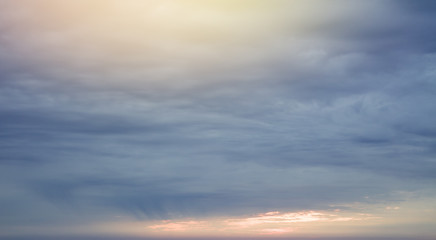 Naklejka na ściany i meble Sunset over ocean. Dramatic cloud in evening sky.