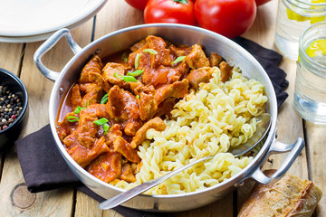 Meat pork in thick tomato gravy with pasta