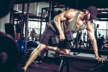 One-arm dumbbell rows in gym