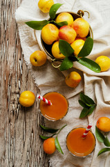 Fresh apricot juice in glass on wooden table, selective focus