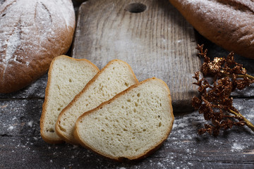 Bread on the wooden background with flour. View from above. Collage with sandwiches, bread, Christmas toys. Advertising bread.