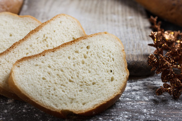 Bread on the wooden background with flour. View from above. Collage with sandwiches, bread, Christmas toys. Advertising bread.